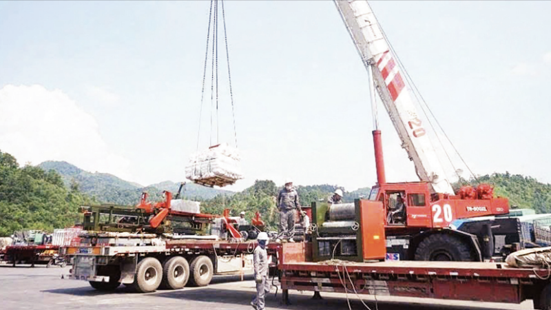 Workers of Huu Nghi Xuan Cuong Joint Stock Company operate specialised cranes for cargo transshipment at Huu Nghi Border Gate in Lang Son Province.