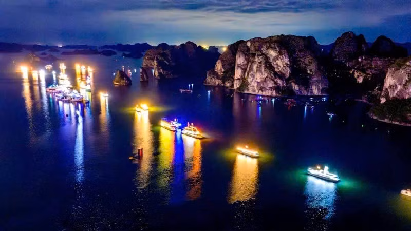 Dozens of brightly lit tourist boats helped illuminate the heritage of Ha Long Bay.