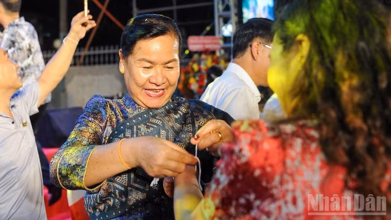 The wrist-tying ritual to offer blessings and prayers for peace.