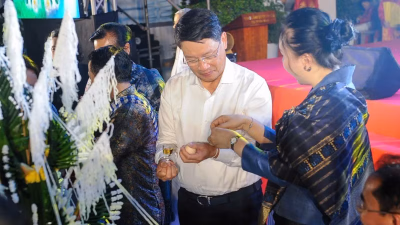 The wrist-tying ritual to offer blessings and prayers for peace.