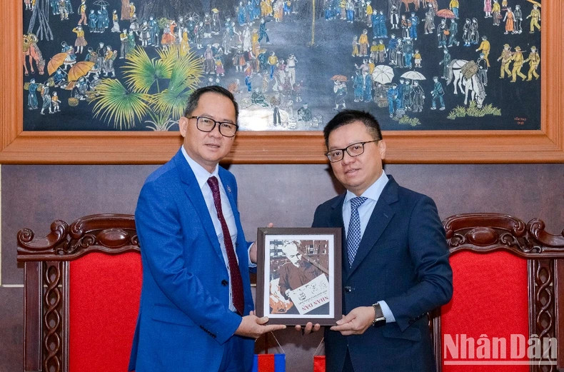 Editor-in-Chief of Nhan Dan Newspaper Le Quoc Minh presents a souvenir to CCJ President Puy Kea.