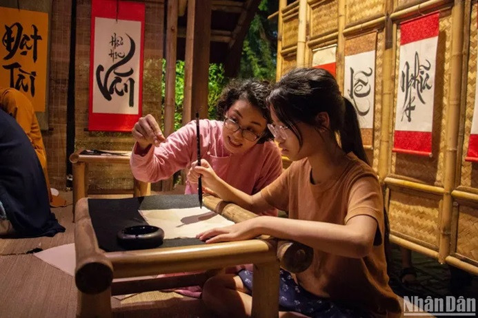 Transformed into an ancient student, Khanh Chi, 22 years old, from Ba Dinh district (Hanoi), experiences calligraphy writing. Transformed into an ancient student, Khanh Chi, 22 years old, from Ba Dinh district (Hanoi), experiences calligraphy writing.