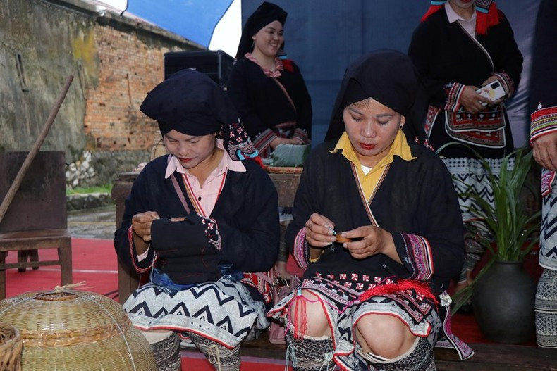 Dao artists perform decorative patterns on fabric. (Photo: Huu Quyet/VNA)
