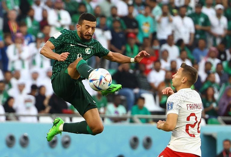 Saudi Arabia’s Abdulellah Al-Malki in action with Poland's Przemyslaw Frankowski. (Photo: Reuters)