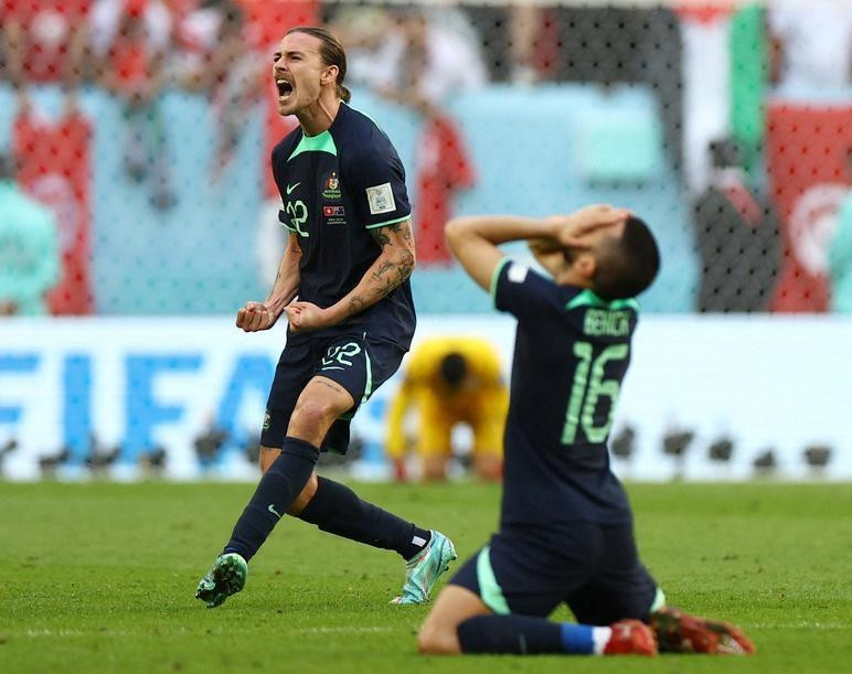 Australia’s Jackson Irvine and Aziz Behich celebrate after the match against Tunisia. (Photo: Reuters)