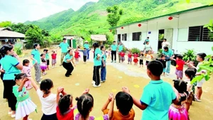 Members of the “Warm Winter for Highland Children” project with students of Pa Phang 2 satellite campus of Phin Ho Kindergarten (Sin Ho District, Lai Chau Province) at the inauguration of two new classrooms. (Photo: nhandan.vn)