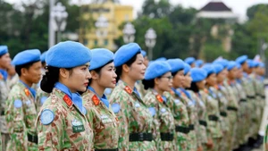 The “steel roses” of Viet Nam’s Peacekeeping Force report their achievements to Uncle Ho after successfully completing international missions in Africa. (Photo: NAM TRAN)