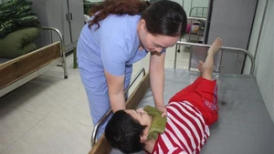 Caring for Agent Orange/dioxin victims. (Photo: VNA)