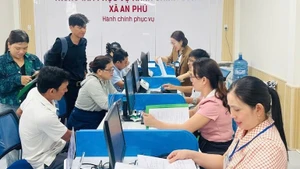 Officers and civil servants in An Phu Commune guide administrative procedures for local people in coastal areas of Quang Ngai. (Photo: NDO)