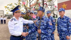 Colonel Le Huy, Political Commissar of Coast Guard Region 2, encourages officers and soldiers before they begin their Tet duty at sea.