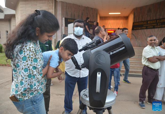 People watch the moon through a telescope during a lunar eclipse in Bangalore, India, Nov. 8, 2022. (Source: Xinhua)
