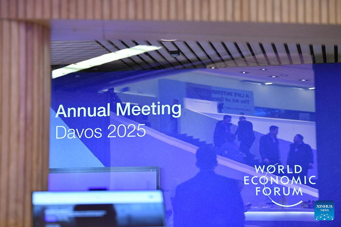 People are reflected on a display panel at the Congress Center for the World Economic Forum (WEF) Annual Meeting 2025 in Davos, Switzerland, Jan. 19, 2025. The Annual Meeting 2025 of the WEF will kick off here on Monday under the theme "Collaboration for the Intelligent Age." (Photo: Xinhua)
