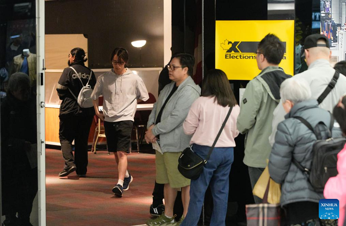 Voters wait in line to cast their ballots at an advance polling station in Richmond, British Columbia, Canada, April 18, 2025. Canada's federal election advance polls opened on Friday, giving voters several days to cast their ballots ahead of the official election day on April 28. (Photo: Xinhua)