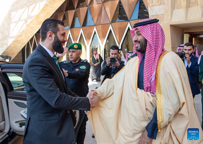 Saudi Crown Prince and Prime Minister Mohammed bin Salman Al Saud (R, front) shakes hands with Syria's interim President Ahmed al-Sharaa (L, front) in Riyadh, Saudi Arabia, Feb. 2, 2025. Syria's interim President Ahmed al-Sharaa arrived in the Saudi capital on Sunday for his first official visit abroad. (Photo: SPA/Handout via Xinhua)