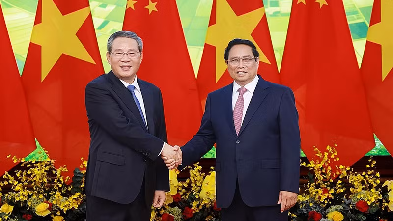 Prime Minister Pham Minh Chinh (R) shakes hands with Chinese Premier Li Qiang. (Photo: VNA)