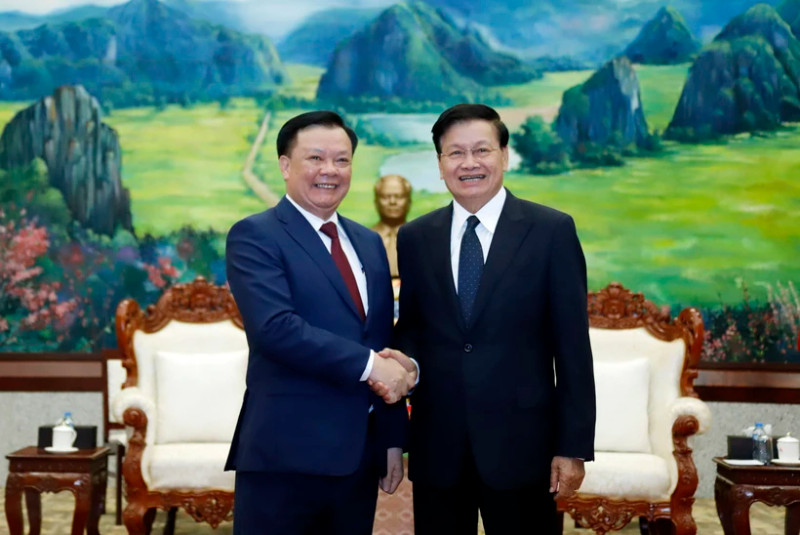 General Secretary of the Lao People’s Revolutionary Party and President of Laos Thongloun Sisoulith (R) welcomes Dinh Tien Dung, Politburo member of the Communist Party of Vietnam and Secretary of the municipal Party Committee, at the meeting in Vientiane on March 12. (Photo: VNA)