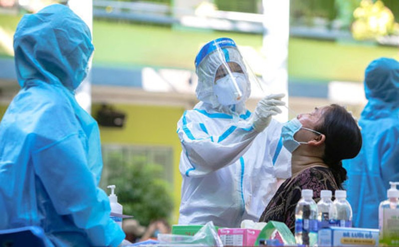 A health worker collects sample for COVID-19 testing.