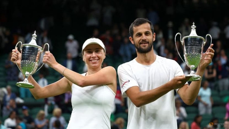 Tennis - Wimbledon - All England Lawn Tennis and Croquet Club, London, UK - July 13, 2023 Croatia’s Mate Pavic and Ukraine’s Lyudmyla Kichenok celebrate with their trophies after winning their mixed doubles final match against Belgium’s Joran Vliegen and China’s Yifan Xu. (Photo: Reuters)