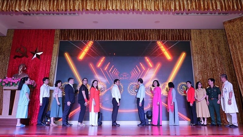 Delegates press the button to officially launch the model.