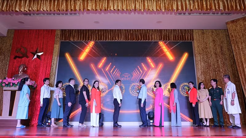 Delegates press the button to officially launch the model.