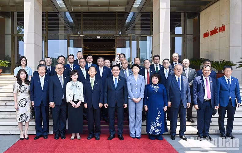 NA Chairman Vuong Dinh Hue and Chairman of the Japan - Vietnam Parliamentary Friendship Alliance Toshihiro Nikai pose for photos with delegates of the two countries.