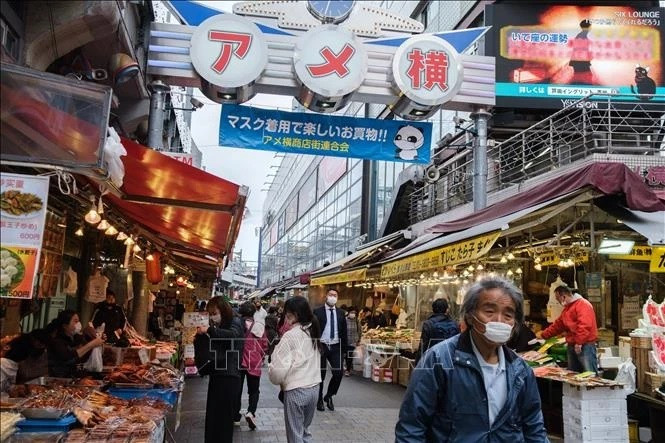 People shop at a market in Tokyo, Japan. (Photo: AFP/VNA)
