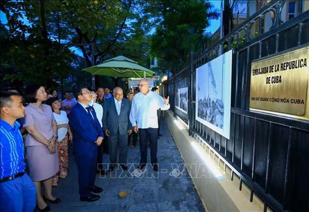 Delegates visit the photo exhibition themed "Great victory of Vietnam and Cuba" (Photo: VNA)