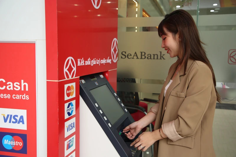 Customers making transactions at ATM.