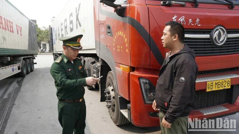 An officer of Chi Ma Border Guard Station checks people and goods passing through the border gate.
