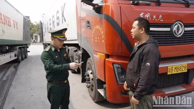 An officer of Chi Ma Border Guard Station checks people and goods passing through the border gate.