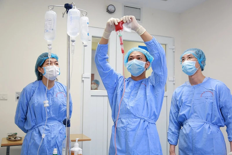 Doctors at the National Institute of Haematology and Blood Transfusion administer a stem cell transplant to a patient.