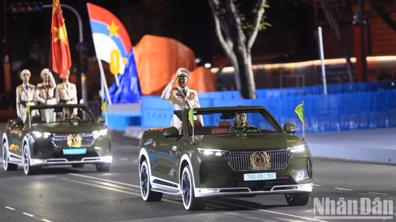 The Vietnam People’s Army marching past the podium, led by a command vehicle carrying senior officers from the Ministry of National Defence.