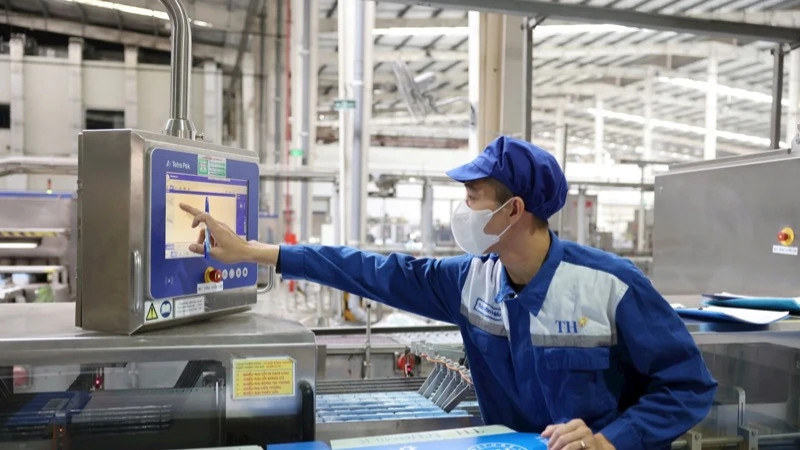 A worker is operating modern technology systems at TH Milk Factory, contributing to reducing greenhouse gas emissions.