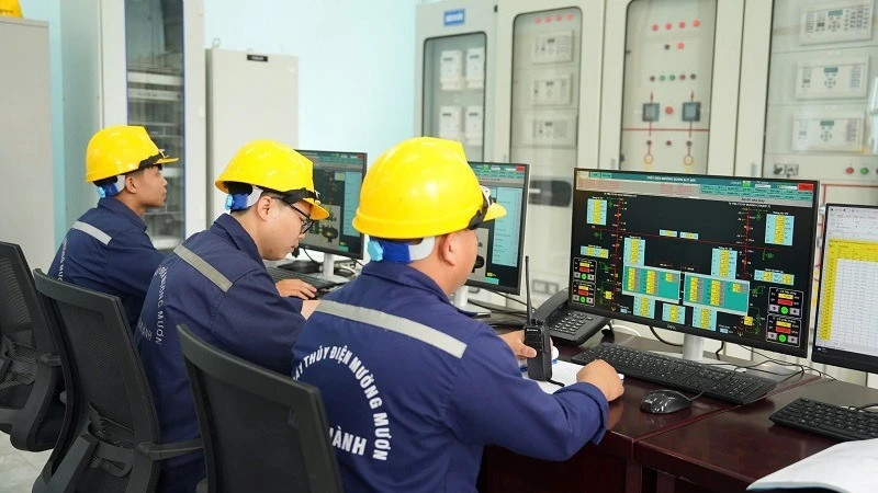 Muong Muon Hydropower Plant workers operating the control system on site