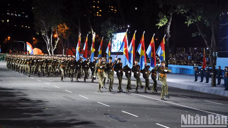 Officers representing the five military wings that entered Saigon on April 30, 1975, march in unison during the parade.