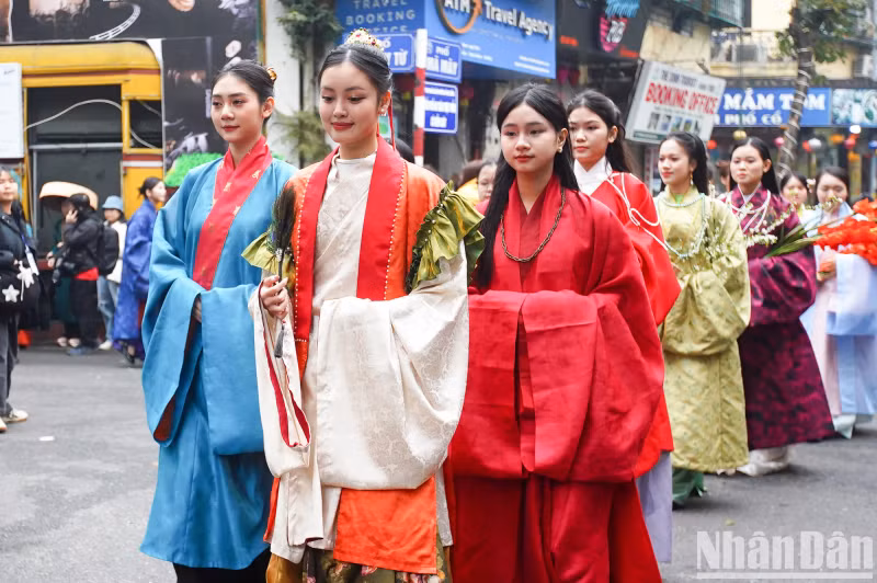 The parade travels through many streets in Hanoi’s Old Quarter, attracting the interest of locals and tourists alike.