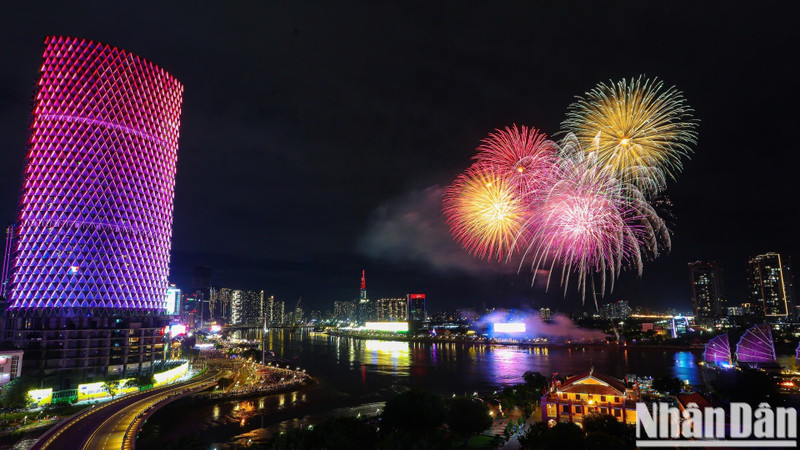 A breathtaking high-altitude firework show illuminates the sky above the entrance of the Saigon River Tunnel.