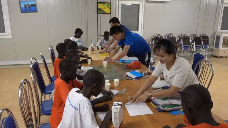 Guiding the children in making toys.