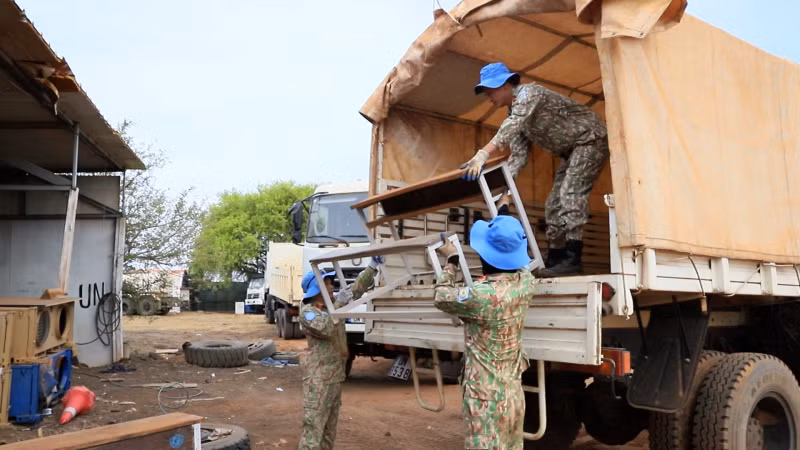 Members of Viet Nam’s Engineering Unit Rotation 3 load and transport the completed desk-bench sets for donation.