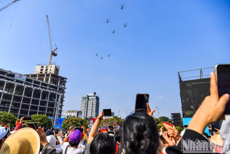 Citizens excitedly capturing breathtaking moments in the sky during the grand celebration.