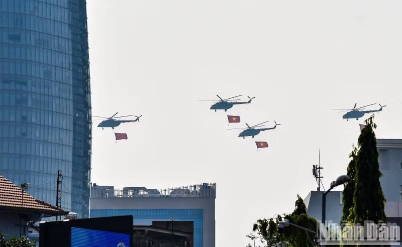 Helicopters carrying the Party and National flags over Ho Chi Minh City.