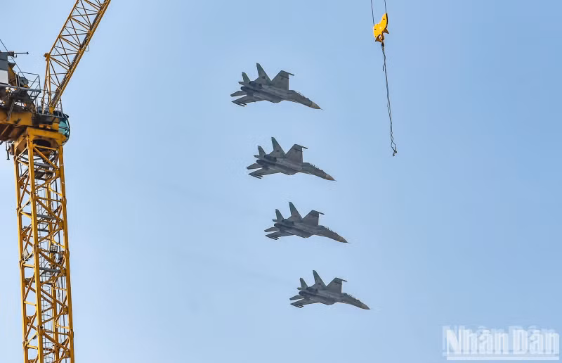 Fighter aircrafts performing a formation flyover above the city.