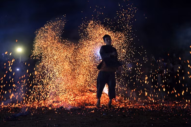 A Pa Then ethnic man dancing on live coals with their bare feet