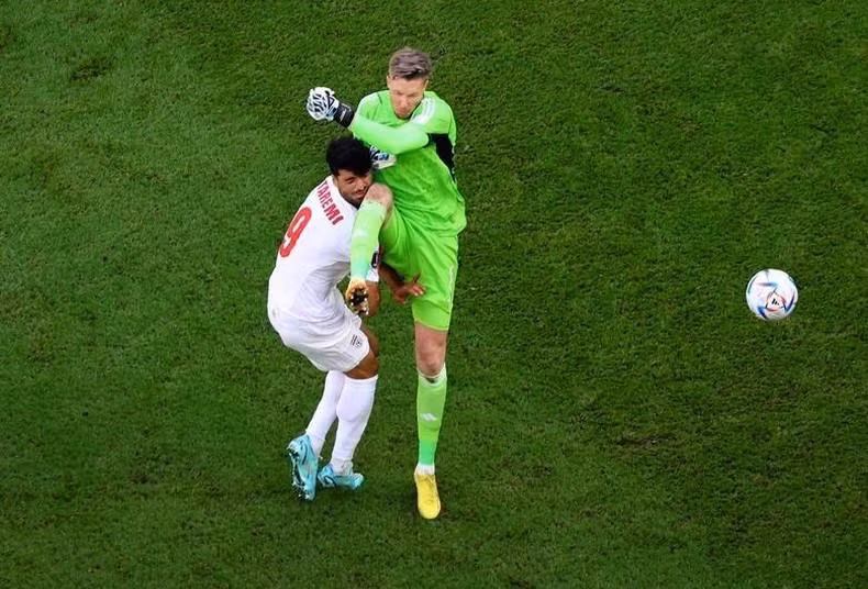 Wales' Wayne Hennessey fouls Iran's Mehdi Taremi leading to a red card. REUTERS/Fabrizio Bensch