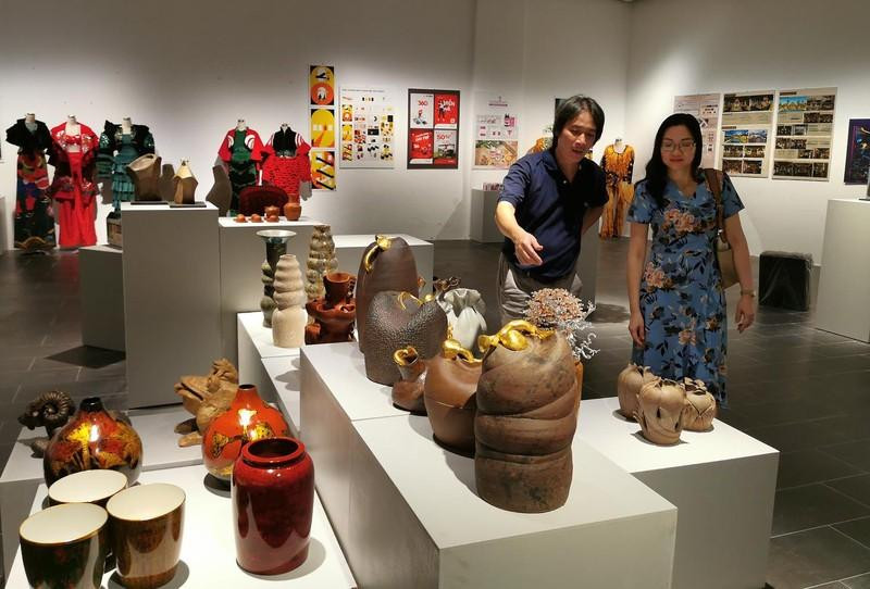 The organising board inspect the display of works at the exhibition.