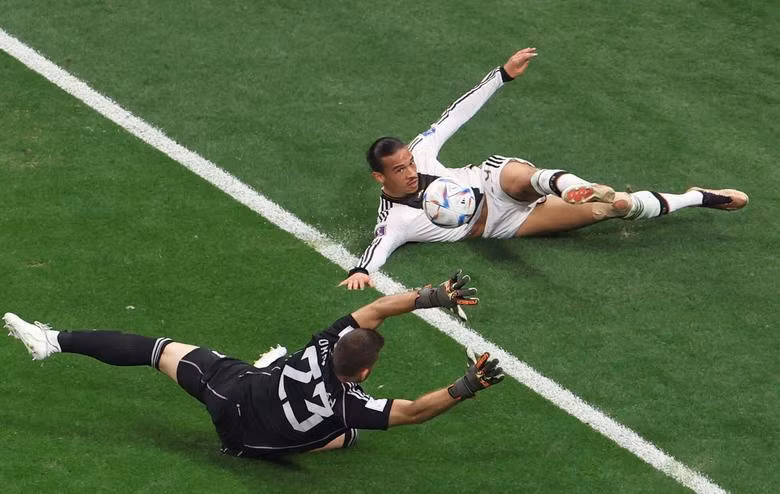 Germany's Leroy Sane in action with Spain's Unai Simon. REUTERS/Molly Darlington