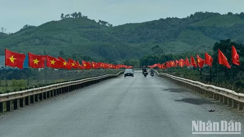 Road adorned with national flags on the way to Phong Nha Cave, Quang Binh Province.