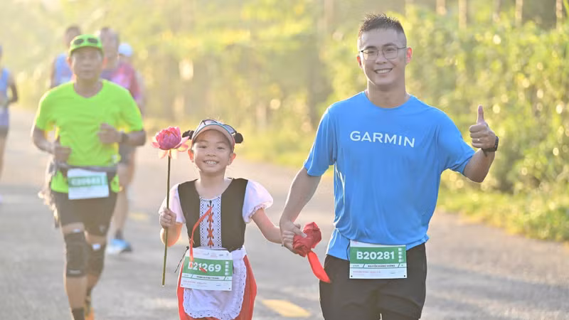 A girl carries a lotus flower during her run.