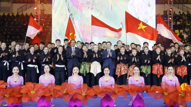 President Vo Van Thuong and his Indonesian counterpart Joko Widodo in a joint photo with athletes and artists at the programme in Hanoi on January 12 (Photo: VNA)
