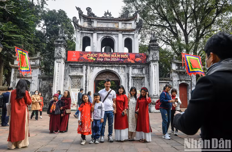 A family pose at the entrance gate to the Temple of Literature.